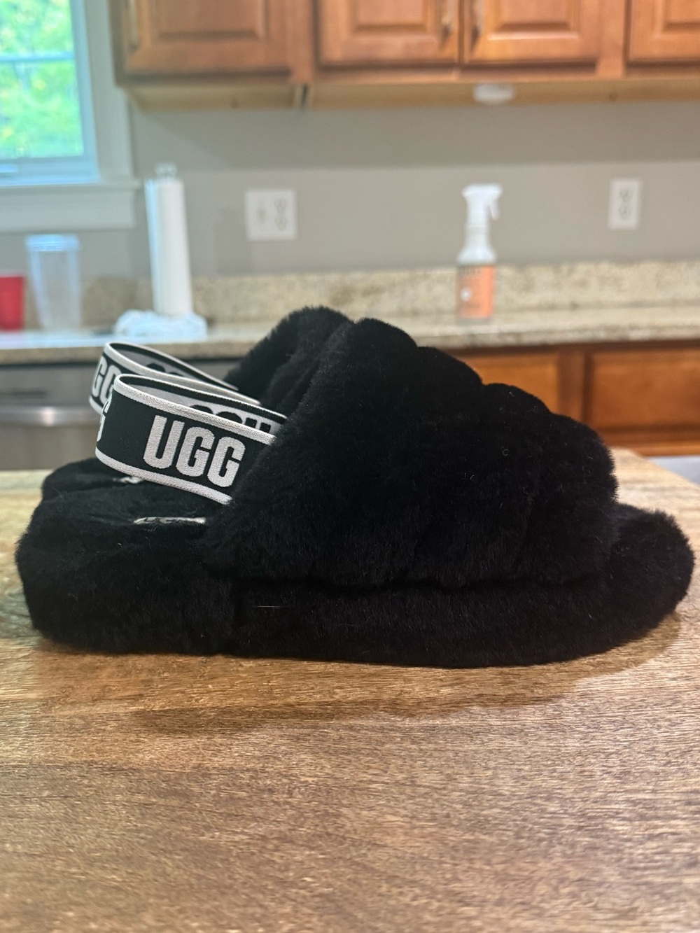 UGG Fluff Yeah Slides featuring soft sheepskin and an elastic logo slingback str